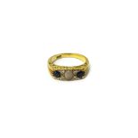 A gold ring, mounted with an oval opal,