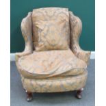 A George I style wingback easy armchair, with bow seat on square cabriole supports,