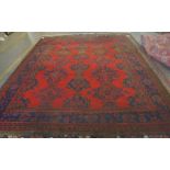 A Turkey carpet, the red field with three columns of stylised medallions,