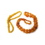 A single row necklace of graduated oval vary coloured butterscotch coloured amber beads,