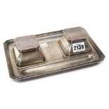 A silver cut cornered rectangular twin bottle inkstand, fitted with two hinged bottle compartments,
