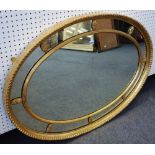 A 19th century gilt framed oval wall mirror with segmented frame, 122cm wide x 86cm high.