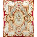 An Aubusson tapestry carpet, the central oval with a rose bouquet, shaped surrounds,