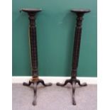 A pair of 19th century ebonised jardiniere stands, with carved columns,
