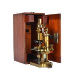 A Ross gilt brass microscope, late 19th century, with rack and pinion focusing and adjustable stage,
