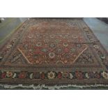 A Mahal carpet, Persian, the madder field with an allover design of palmette and floral sprays,