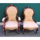 A lady's and gentleman's pair of carved Victorian mahogany framed easy chairs,