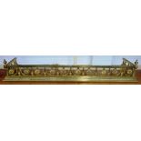 A Victorian gilt brass fire fender, with pierced foliate rail over an engraved stepped plinth,