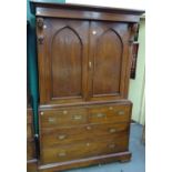 A 19th century oak linen press, the pair of Gothic arched doors over two short and two long drawers,