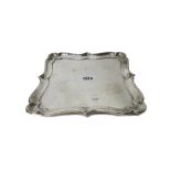 A silver salver, of shaped square form, with a pie-crust rim, in the early 18th century taste,