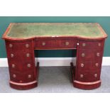 A 19th century mahogany double bowfront writing desk, with nine drawers about the knee,