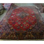A Maymeh carpet, Persian, the madder field with an indigo diamond, with matching spandrels,