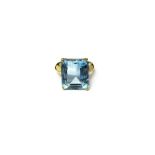 A gold ring, claw set with a cut cornered rectangular step cut aquamarine, detailed 750,