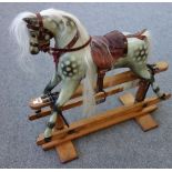 A Victorian style dapple grey rocking horse, with leather saddlery,