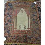 A Ghirordes prayer rug, the plain ivory mehrab with two pillars rising to an indigo arch,