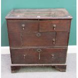 A small 18th century oak chest with two short and one long drawer about central cupboard,