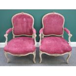 A pair of Louis XV style open armchairs, with serpentine seats and scroll supports,