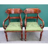 A pair of mid-19th century mahogany framed open armchairs, each with carved crest rail,