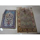 A Hereke silk rug, early 20th century, the pale green field with vase, flowers and birds, signed,