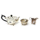 A silver three piece tea set, comprising; a teapot, a sugar bowl and a milk jug,