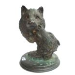 A modern patinated bronze depicting two wolves heads, indistinctly signed '....