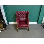 A mid-18th century style brass studded rouge leather upholstered wingback armchair,