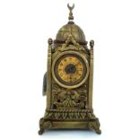 A Turkish brass cased mantel clock, 20th century, with domed top over a square turret body,