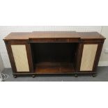 A Regency rosewood side cabinet with open shelves flanked by pleated silk panel doors,