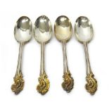 Four European silver and parcel gilt dessert spoons, decorated with gilt scrolling motifs,