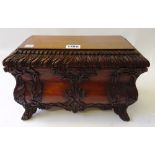 A Rococo Revival carved mahogany bombe shaped casket, with lift-off rectangular top,
