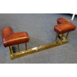 An Art Deco brass and leather upholstered club fender,
