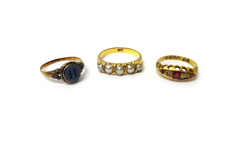A gold ring, mounted with a row of five graduated half pearls, detailed 18 CT, an 18ct gold,