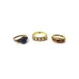 A gold ring, mounted with a row of five graduated half pearls, detailed 18 CT, an 18ct gold,