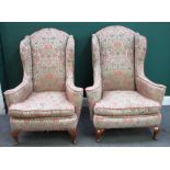 A pair of George I style high wingback armchairs, on beech squat cabriole supports,