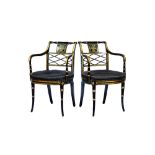 A pair of Regency ebonised parcel gilt floral painted lattice back open armchairs,