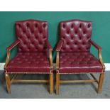 A pair of George III style brass studded rouge leather upholstered open armchairs,
