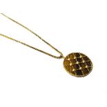 A 9ct gold mounted tiger's eye circular pendant, the front with lattice work decoration,