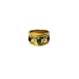 A gold ring, mounted with an oval cabochon sapphire,