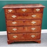 A mid-18th century figured walnut chest of three short and four long graduated drawers,