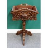 An early 20th century Black Forest carved oak jardiniere, on tripod base, 60cm wide x 99cm high.