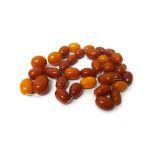 A quantity of mostly darker butterscotch colour oval amber beads, combined gross weight 59 gms.