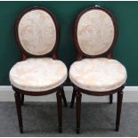 A pair of late 19th century mahogany framed oval back side chairs, on reeded supports,