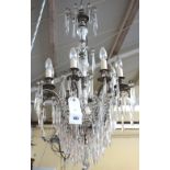 A late 20th century white metal and glass mounted eight branch chandelier,