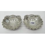 A pair of Italian butter shells, of scallop form, each raised on three feet, detailed 800,