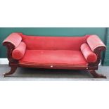 A George IV mahogany framed sofa, with stylised cornucopia arms, and out splayed supports,