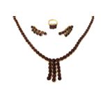 A gold and carbuncle garnet set necklace, designed as a row of graduated circular carbuncle garnets,