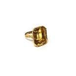 A gold ring, mounted with a cut cornered rectangular step cut citrine, detailed 750,