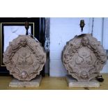 A pair of shaped and carved stone table lamps (formerly architectural embelishments),