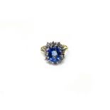 An 18ct gold, sapphire and diamond set oval cluster ring,