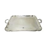 A silver shaped rectangular twin handled tray, presentation inscribed, Sheffield 1913,